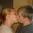 Two people in a close embrace with one person kissing the other's cheek, overlaid with pink pixelated text reading "I LOVE MIKE".