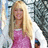 A pixelated image of a person with long blonde hair wearing a pink dress and white cardigan, standing against a blurred background with a bright pink text on the right