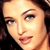 Pixelated close-up of a person's face with light skin tone, dark brown hair, and visible eyes, nose, and lips.