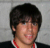 A person with dark hair and a red necklace appears in , overlaid by blue star icons that change from solid to pixelated