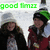 Two figures stand side-by-side under a green 'good times' text banner; one wears dark clothing with long hair, the other red and black attire with a green headband.