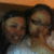 Two pixelated figures with dark hair and light skin tones appear in close proximity, one wearing a light blue garment against an orange-brown background.