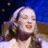 A pixelated image divided into four quadrants with a woman's face in the top-left and green text on black backgrounds in other sections.