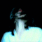 A woman with long dark hair and red eye makeup appears in a of frames showing her head movements against a black background