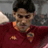 Static 48x48 pixel icon showing a person in a red sports jersey with dark hair and facial stubble, set against a blurred background.