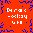 Red background with blue pixelated border and central starburst; four identical text blocks reading 'Beware Hockey Girl!' in white pixelated font.