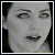 Static grayscale pixelated image of a person's face with visible facial features and mouth open, framed by dark background.