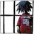 Pixelated figure with dark blue and black hair stands facing a grid of white panes, wearing a maroon shirt with a light gray square graphic on the back.