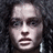 Pixelated image of a person with long dark hair on left, black background with white pixelated text on right reading "Who are you calling insane?!"