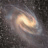 A pixelated static image of a spiral galaxy with swirling light brown and white arms against a dark gray background.
