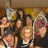 Group of people holding tennis rackets in a pixelated image with two kissing figures on the right.