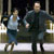 Two pixelated figures in motion, one in light clothing and one in dark clothing, against a blurred background with vertical elements.