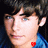 Two side-by-side pixelated images of a person with dark hair and blue eyes, wearing a blue shirt with red heart symbols on the collar.