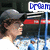 Pixelated image of a person wearing a gray cap and light blue shirt, with red rectangular shapes in the background.