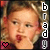 A pixelated image of a person with light brown hair styled in curls, wearing red earrings and a dark top, with vertical text reading 'brady' on the right side.
