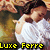 A pixelated image of a person in a white shirt with a hand near their face, overlaid with yellow and red text reading "Luxe Ferre" at the bottom.