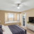 Pixelated static image of an interior space with light-colored walls, a ceiling fixture, and indistinct furniture shapes.