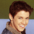 Pixelated image of a smiling person with brown hair on left, pink background with white text on right.