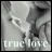Static grayscale image of two children on a teeter-totter with 'true love' text at the bottom, rendered in pixelated style.