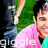A pixelated image with a bright green background, featuring a partial photo of a person in a pink shirt and a green backdrop, alongside pink pixelated text.