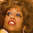 A 3x2 contact sheet of pixelated frames showing a woman with voluminous curly hair in various poses and expressions, with a yellow banner displaying "Coolbuddy.com" at the bottom center.