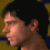 Four pixelated head-and-shoulders views of a person with dark hair against a yellow and blue patterned background, showing different angles and expressions.