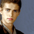 Static pixelated image of a person's face and upper shoulders against a solid gray background, rendered in low-resolution with visible dithering and color banding.