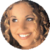 Circular cropped image of a person with curly light brown hair smiling, showing teeth, with eyes looking left in one frame and right in another.