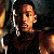 A pixelated image of a person with dark hair and earrings against a dark background, next to green text reading 'Original Icons .com' on a solid green backdrop.
