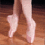 A pixelated image of a dancer's feet in ballet shoes on a wooden floor, with pink background text reading "Dancers ROCK the house".