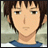 Pixelated anime-style character face with short brown hair and blue shirt against blurred background.
