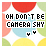 12 pixel-art icons with 'OH DON'T BE CAMERA SHY' text, each featuring a unique heart symbol and color variation in the background