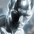 A pixelated grayscale image shows a dark, irregularly shaped central form against a light, blurred background with scattered bright spots.