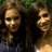 Two people with long curly hair stand side-by-side against a green background, next to bright pink text reading 'bestfriends' in pixelated font.