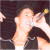 Pixelated image of a person singing into a microphone with blue text reading "rocking rocking with greg" on black background.