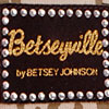 Black rectangular icon with gold text bordered by silver studs, displaying 'Betseyville' and 'by BETSEY JOHNSON' in stylized fonts.