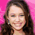 A woman with long brown hair appears in multiple poses against varying backgrounds including pink, green, and beige, with a heart-themed animation featuring text.