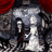 Pixelated static image shows a figure in dark clothing with red accents standing against a gray and white background, partially obscured by pixelation.