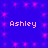 Blue background with pink star-like sparkles and four instances of the name 'Ashley' in white pixelated text arranged in a