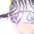 Pixelated close-up of a character's face with light skin, dark hair, and glasses, set against a pale background with yellow and pink tones.