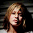Pixelated image of a woman with blonde hair and white text reading "Kelly Clarkson" on black background.
