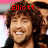 A person with curly brown hair and a black jacket smiles in four , each showing different text above the head