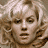 A 48x48 pixel animated contact sheet showing three sampled frames of a blonde woman with curly hair in different poses and expressions, displayed on a gray background.