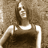 Static grayscale icon of a person in a sleeveless top with visible shoulder straps, set against a textured background.
