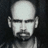 A 4-frame black-and-white contact sheet animation of a bald man with facial hair performing sequential hand gestures against a dark background.