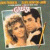 Animated image featuring a 'Grease' movie poster, text reading 'Sandy + Danny equals true love', and two heart-and-arrow icons with varying pixel density.