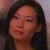 A pixelated close-up of a person with dark hair, closed eyes, and a neutral expression against a blurred background.