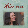 Animated sequence showing two people in a kissing motion with red lipstick marks, framed by 'Kiss one' text on a light green background.