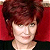Static 50x50 pixel icon showing a person with short brown hair against a solid red background, wearing dark clothing and visible light-colored neck area.
