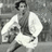 Black-and-white pixelated image of a person in motion holding a soccer ball, with text overlays on black background.